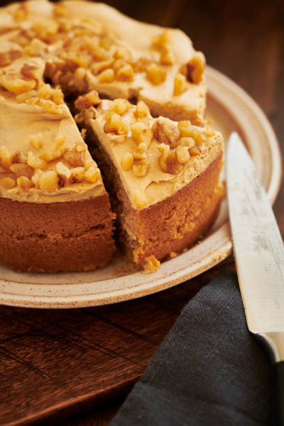 istock Coffee and walnut cake on aged dark wood rustic surface. 1169328994