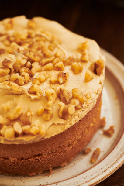 istock Coffee and walnut cake on aged dark wood rustic surface. 1169329009