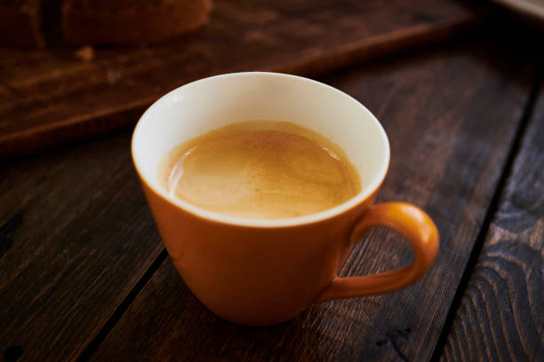 istock Orange cup with freshly brewed espresso coffee. 1169329064