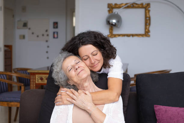 istock Mother and daughter with closed eyes hugging 1169329113
