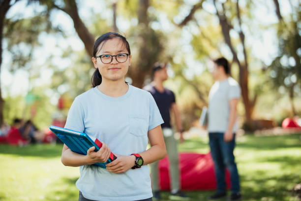 Ready for Exam Season A front-view shot of a young university student standing proud with a smile, she is wearing casual clothing and looking at the camera. university students australia stock pictures, royalty-free photos & images