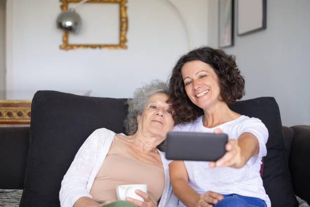 istock Happy mother and daughter taking selfie 1169329422