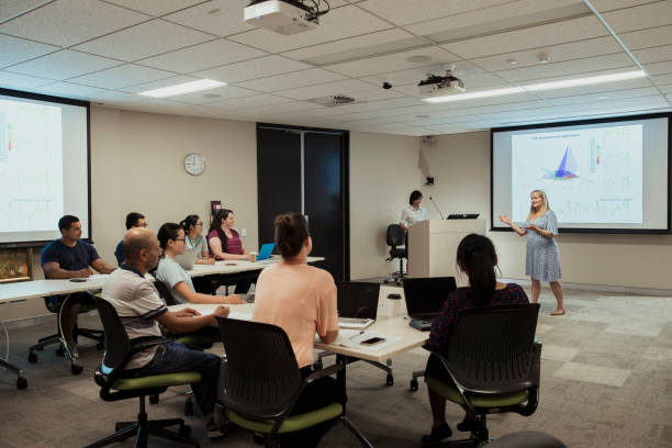 istock Female Scientist Giving Presentation 1169330430