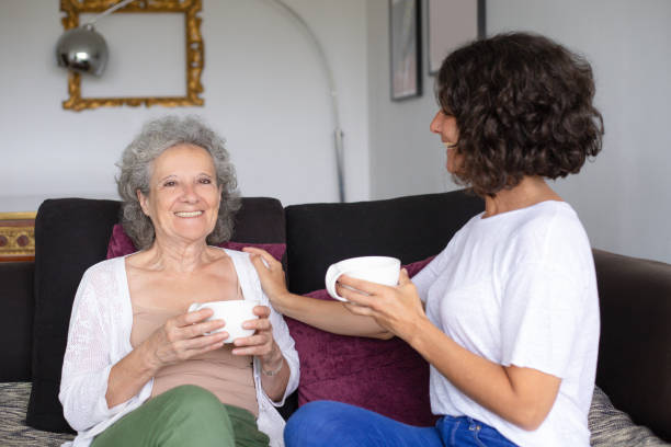 istock Cheerful mother and daughter drinking tea 1169330492