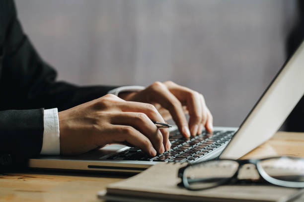istock Close up Businessman hands using laptop.financial concept 1169330635