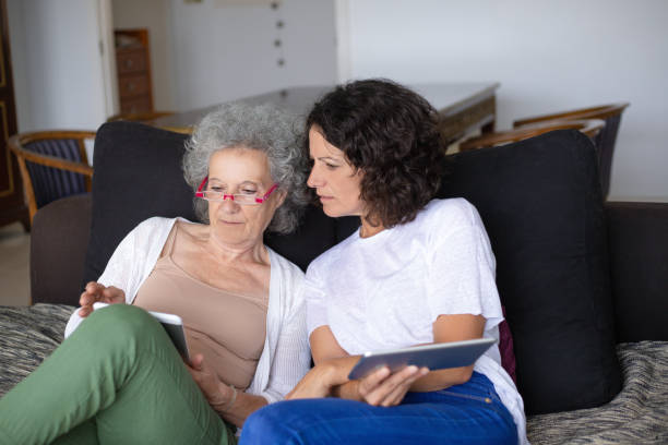 istock Concentrated mother and daughter with digital tablets 1169332185