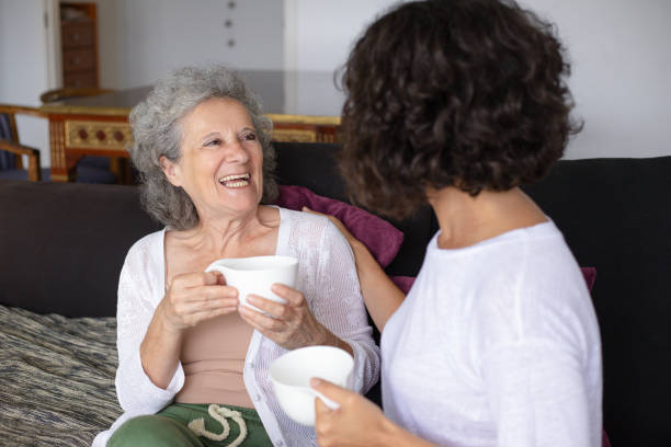 istock Smiling mother and daughter drinking tea 1169332510