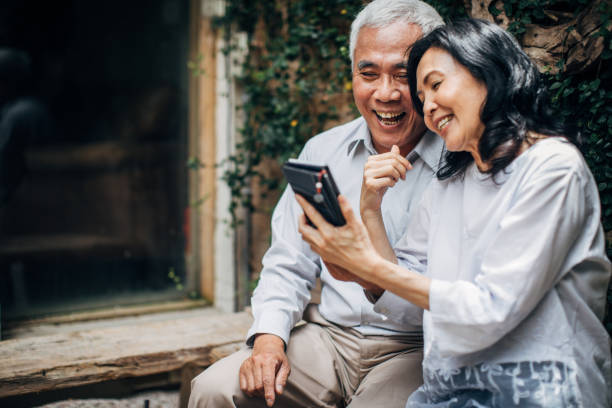 istock Senior couple using phone together 1169333664