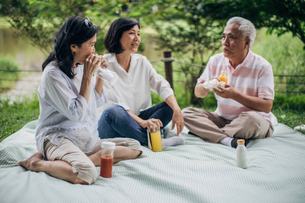 istock Three senior friends on picnic in park 1169334097