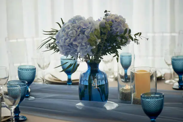 Wedding decoration of the Banquet hall for the wedding in blue. Hydrangea.Blue glasses