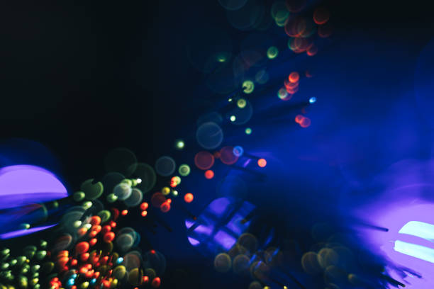 istock Beautiful abstract fiber optical network cable on a multi colored glow background. 1169334379