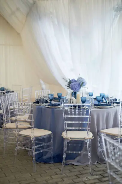 Wedding decoration of the Banquet hall for the wedding in blue. Hydrangea.Transparent chairs.