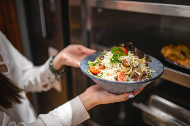 Female chef showing off her vegan meal