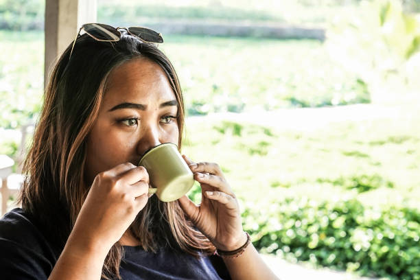 istock a asian woman is drinking tea 1169336874