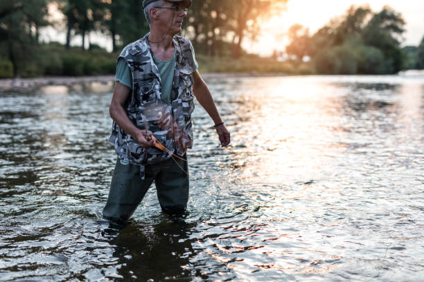 istock Fisherman on the river at sunset 1169337117
