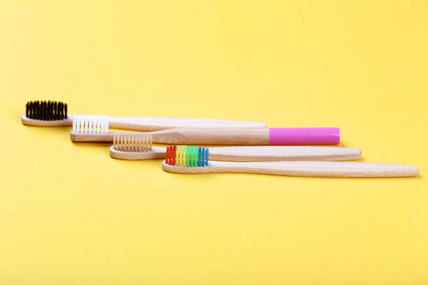 istock Bamboo toothbrushes on yellow background 1169337212