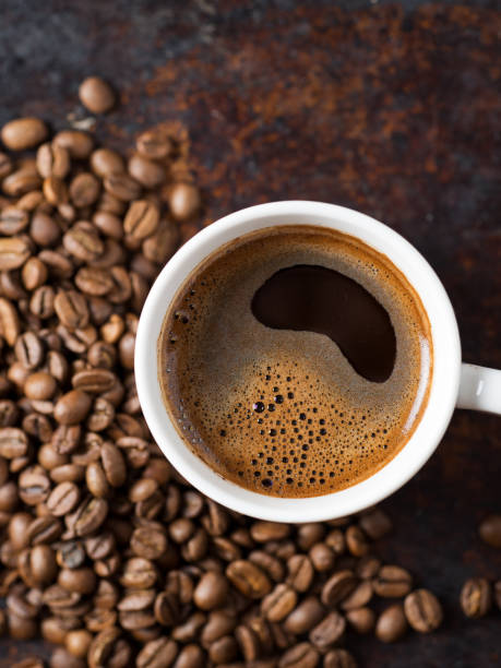 istock A Cup of espresso on a rusty background with scattered roasted coffee beans 1169339665