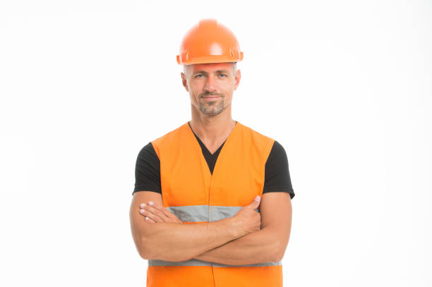 istock Safety is main point. Man protective hard hat and uniform white background. Worker builder confident looking camera. Protective equipment concept. Builder crossed hands chest. Strong handsome builder 1169341410