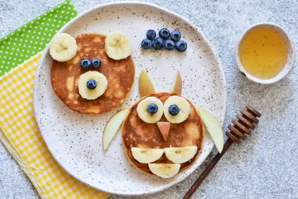 Photo of Funny pancakes for kids - bear and owl. Breakfast for children.