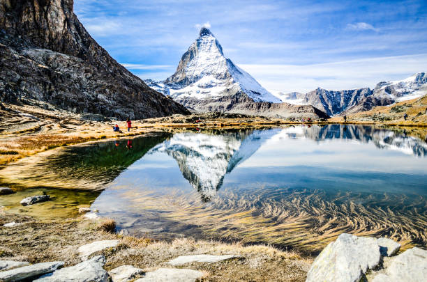 Matterhorn, mirrored in the Riffelsee, Zermatt, Valais, Switzerland stock photo