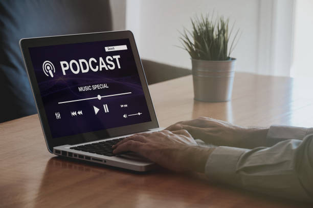 istock Podcast website in a laptop computer while man types on the keyboard. 1169349310