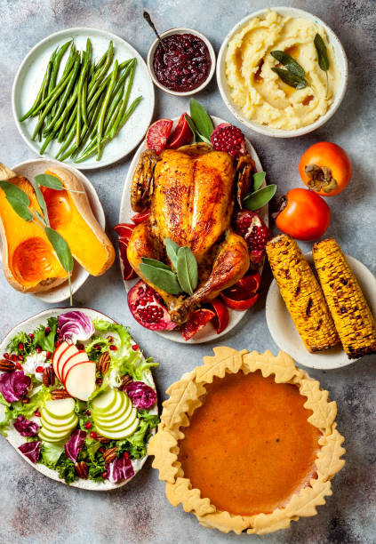 thanksgiving dinner table with roasted whole chicken or turkey, green beans, mashed potatoes, cranberry sauce and grilled autumn vegetables. top view, overhead. - thanksgiving dinner party turkey feast day imagens e fotografias de stock
