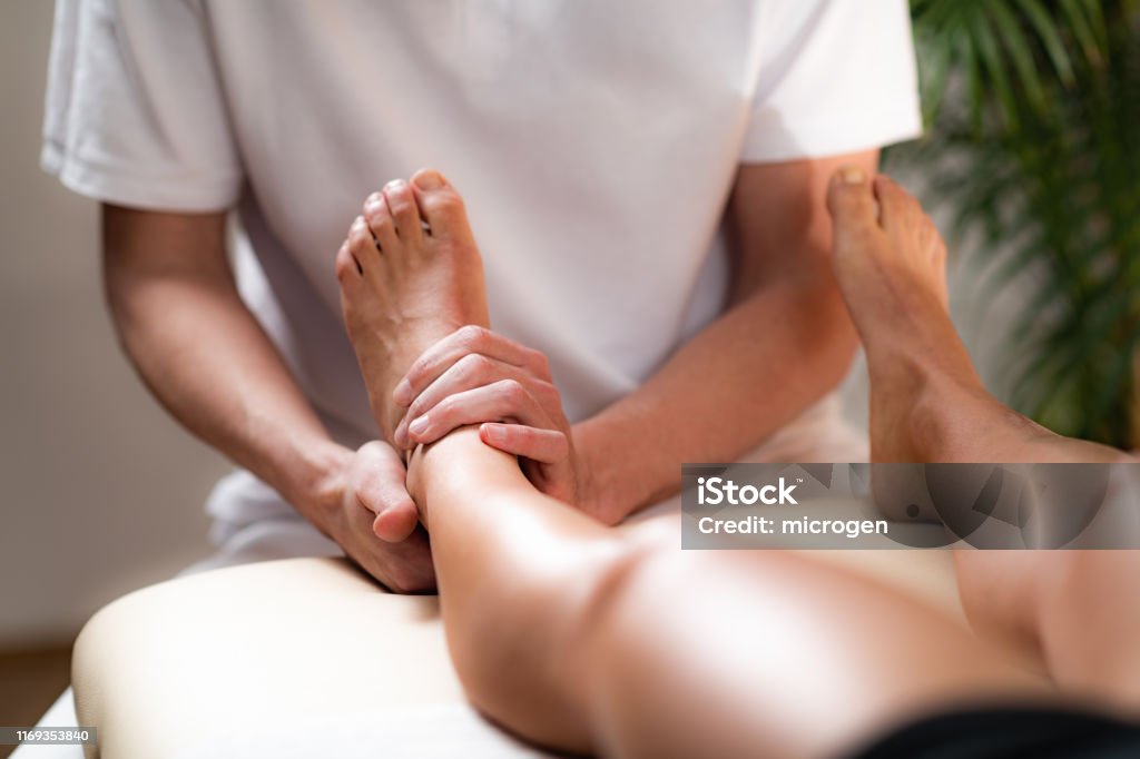 Leg Pain Osteopathy Treatment. Osteopathy Treatment on Patient’s Leg Massaging Stock Photo