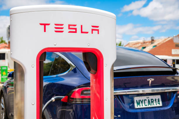 Tesla Supercharger and Tesla Model X car Adelaide CBD, Australia - November 18, 2017: Tesla Supercharger EV charging station with Tesla Model X car in city centre on Franklin Street on a day giant fictional character photos stock pictures, royalty-free photos & images
