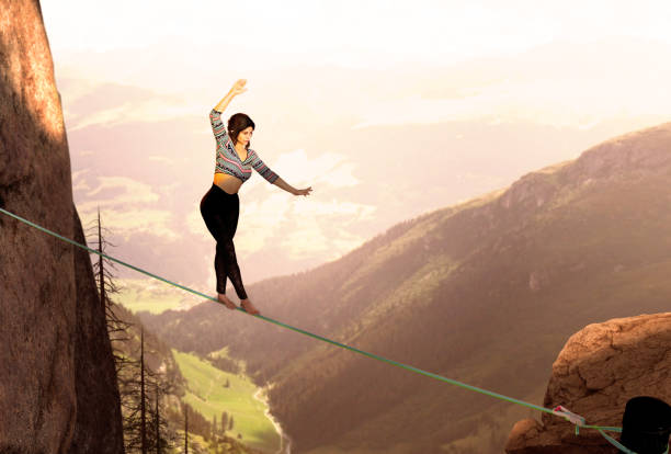 istock Attractive Woman Slacklining Highlining In The Mountains 1169356245