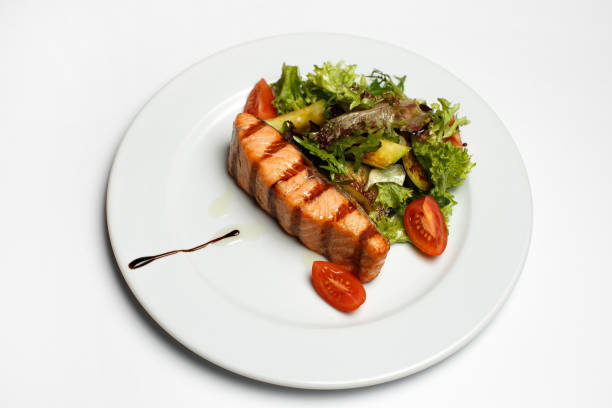 istock grilled salmon steak with vegetable salad 1169360280