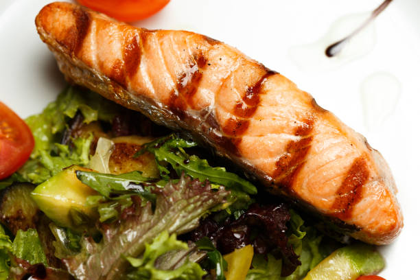 istock grilled salmon steak with vegetable salad 1169360650