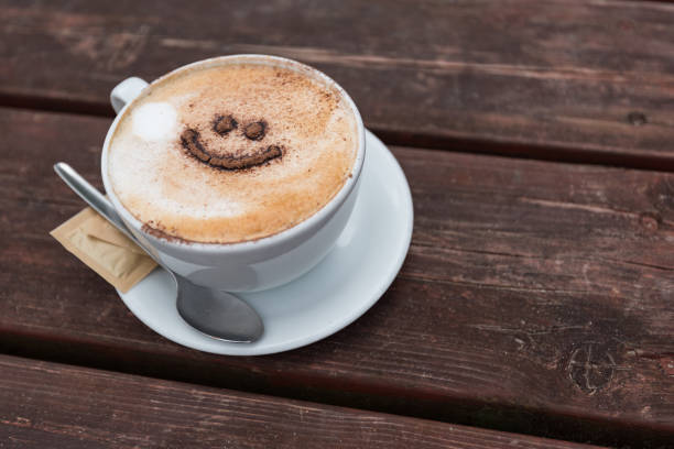 istock Cup of coffee with a smile face 1169363585