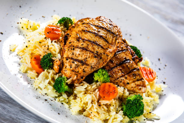 istock Roast chicken filets with rice and vegetables 1169367574