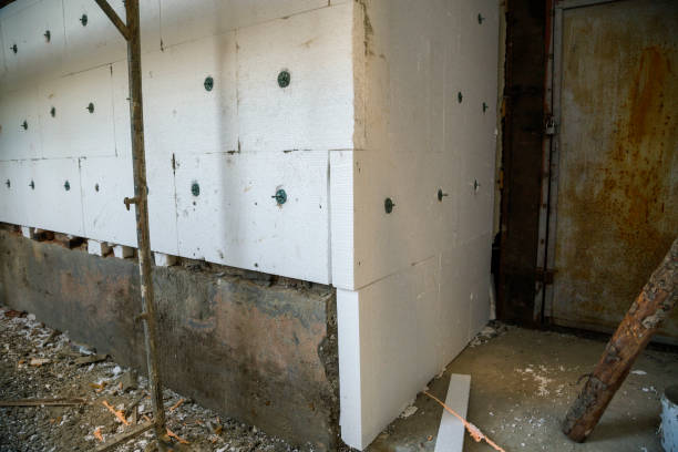 istock Insulation work of house walls with styrofoam sheets. 1169368043