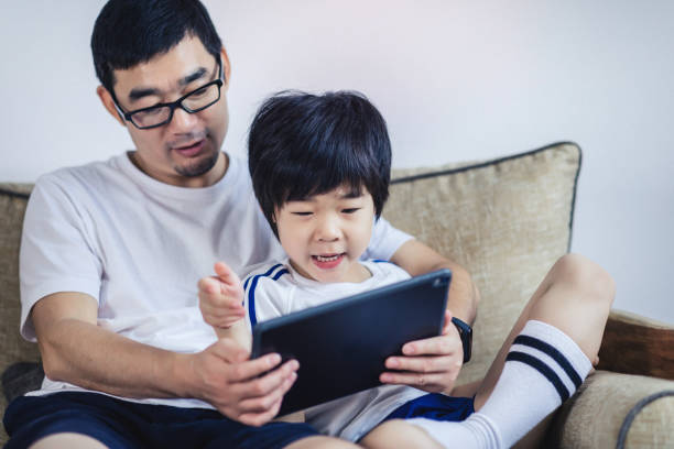 istock A father playing with his son on the sofa at home 1169368566