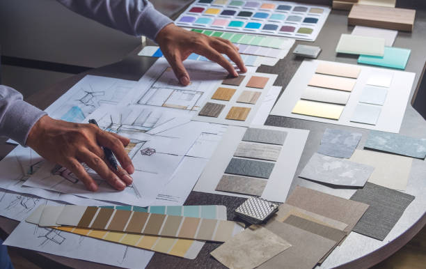 istock Architect designer Interior creative working hand drawing sketch plan blue print selection material color samples art tools Design Studio 1169370214