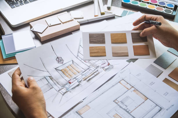 istock Architect designer Interior creative working hand drawing sketch plan blue print selection material color samples art tools Design Studio 1169370216