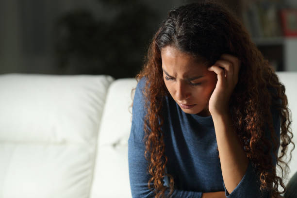 istock Sad mixed race woman complaining at home 1169371372