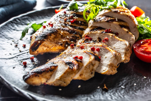 istock Chicken breast grilled with spices peper salt tomatoes and arugula 1169371510