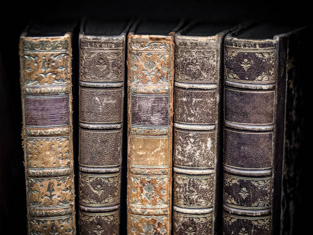 istock Old vintage books on black textured background 1169371819