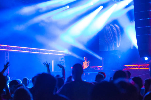 istock Dj playing techno music on the stage 1169372129
