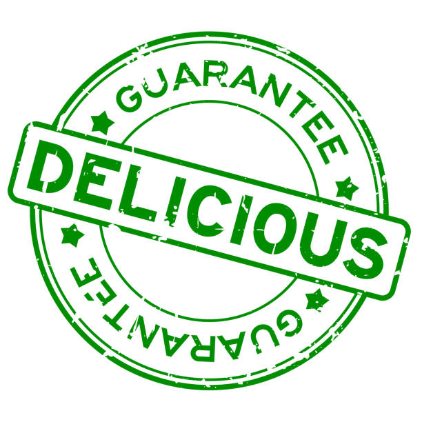 istock Grunge green delicious guarantee word round rubber seal stamp on white background 1169373463