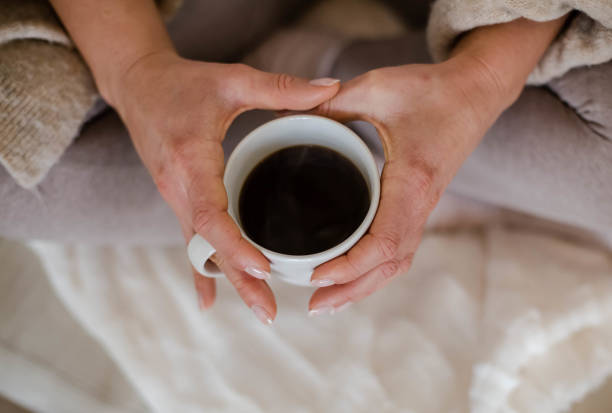 istock Holding a cup of coffee 1169373635