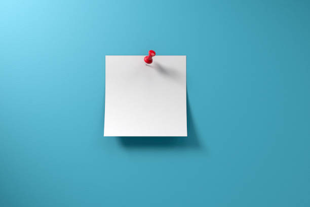 Adhesive Sticky Note and Thumbtack on Blue Background Blank adhesive sticky note and red thumbtack on a blue background with copy space. pinning stock pictures, royalty-free photos & images