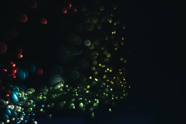 istock Beautiful multi colored bokeh background on a dark. 1169377003