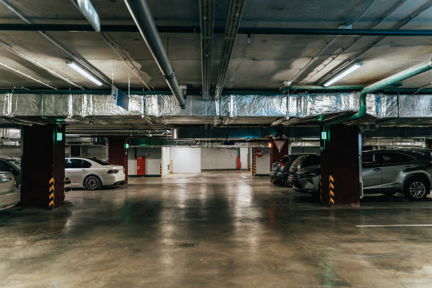 istock Parking Garage, Illuminated Underground Car Park Lots under modern Mall with Vehicles 1169377092