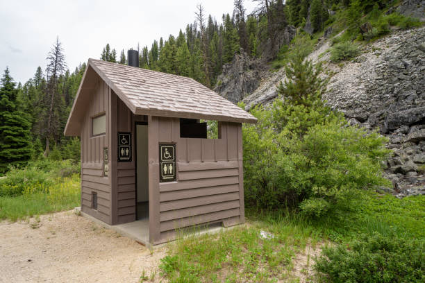 istock Rustic pit vault toilet bathrooms outdoors with one stall and handicap access 1169377276