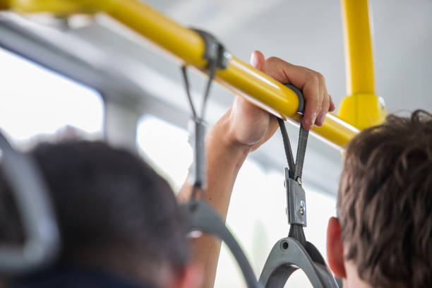 istock People holding onto a handle on a subway train,Passenger standing in public transportation. Person commuting. Commuter going to work. 1169378047