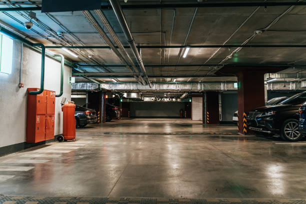 istock Parking Garage, Illuminated Underground Car Park Lots under modern Mall with Vehicles 1169378707