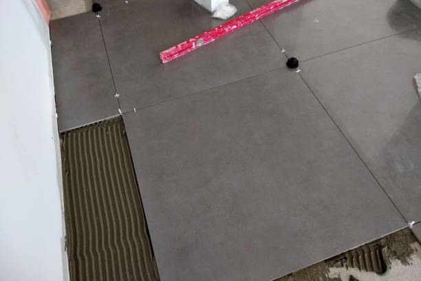 istock Ceramic tiles and tools for tiler. Floor tiles installation. Home improvement, renovation - ceramic tile floor adhesive, mortar, level 1169379644